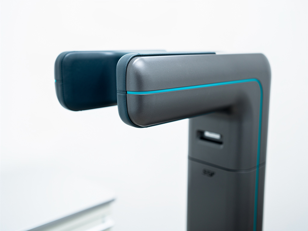 Close-up of a positioning guide and head support aligned on a graphite capture stand.